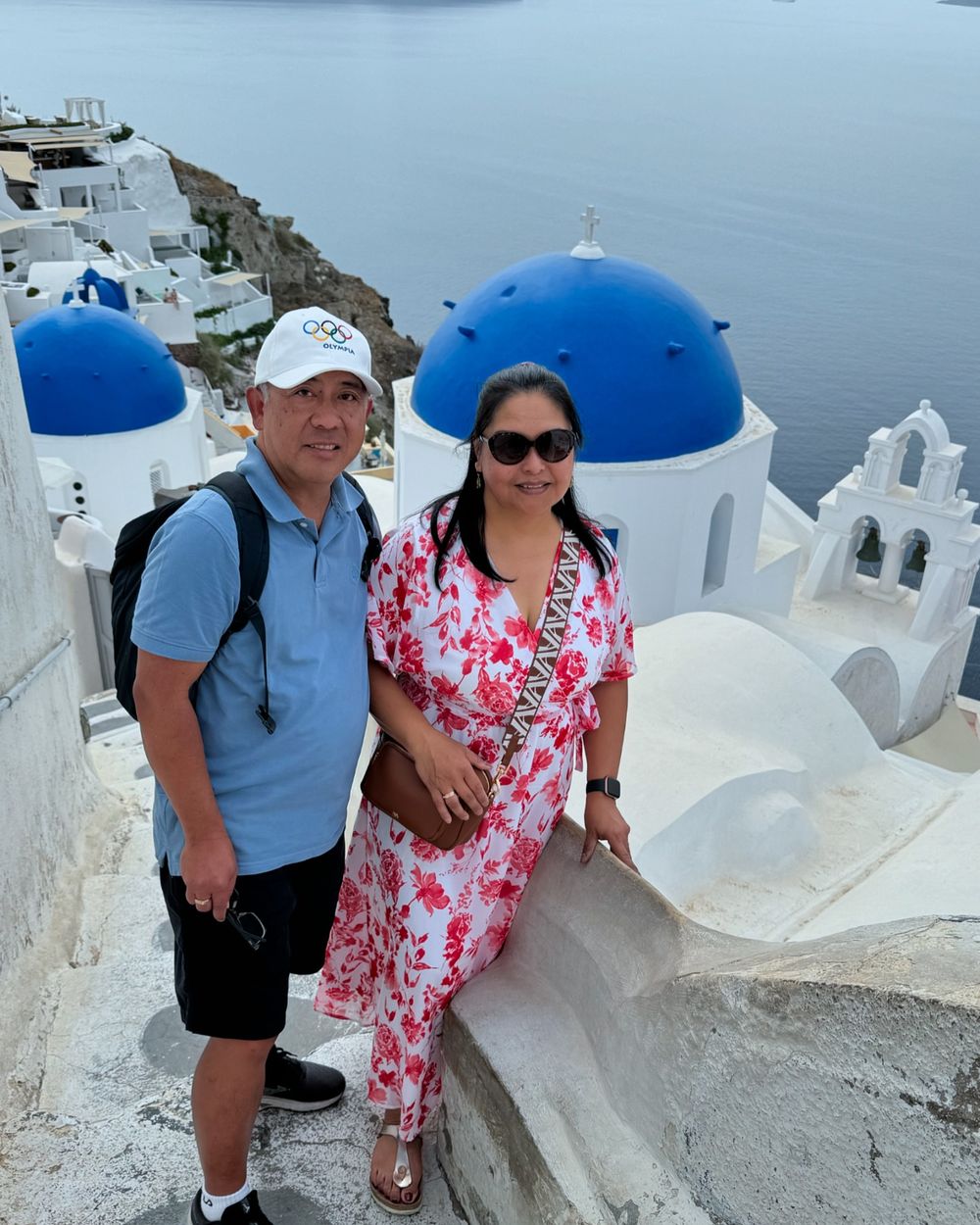 Travellers above the blue domes of Oia
